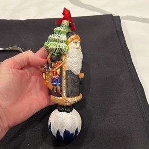 The Christopher Radko Company Oxford Santa 1 Glass Ornament is a 8-inch glass